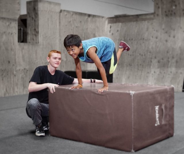A man and boy are playing with an object.